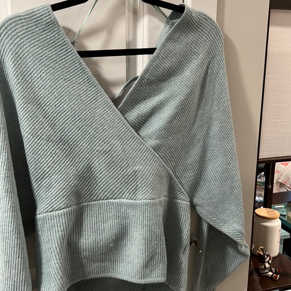 Blue open back sweater with tags